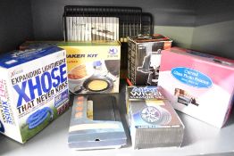 A selection of boxed items including a pancake maker kit, an Xhose expanding garden hose, a Logic