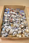 A collection of assorted collectors display teaspoons.