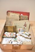 A small carton of cigarette and trade cards with a large range of loose trade cards along with