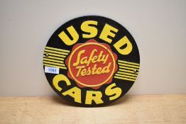 A cast plaque 'used Cars Safety Tested'