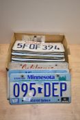A box of US number plates Approx 23