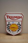 A cast Triumph Shell shield shaped plague