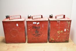 Three vintage fuel cans Shell-Mex, BP, and Esso with brass caps