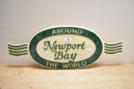 A hard Plastic Around the World Newport Bay sign
