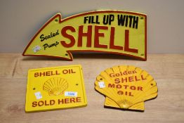Three cast plaques. Golden Shell Motor Oil, Shell Oil Sold Here, and Fill Up with Shell - Sealed