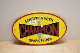 A cast Equipped with Champion Spark Plugs plaque