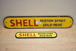 Two cast Shell Motor Spirits Sold Here signs