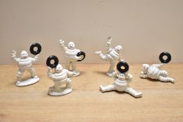 Six cast Michelin men in various poses
