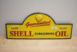 A cast Guaranteed Shell Lubricating Oil sign