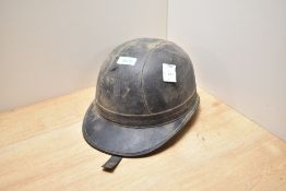 A vintage cork lined leather Motorcycle helmet