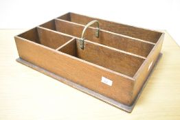 An early 20th-century Georgian-style oak cutlery tray with brass handle, featuring four