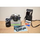 A Yashika X-D Quartz 35mm film camera; sold with Tamroon Adaptall-2 Custom Mount for Yashica/Contax,