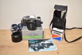 A Yashika X-D Quartz 35mm film camera; sold with Tamroon Adaptall-2 Custom Mount for Yashica/Contax,