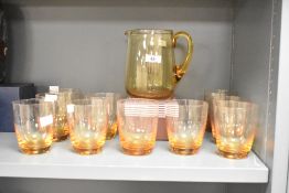 A quantity of mid 20th-century Whitefriars Crystal amber studio glass pitcher set with matching