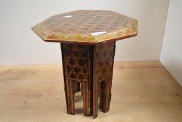 A late 19th to 20th-century Anglo-Burmese lacquer octagonal folding side table, featuring a