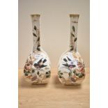 A pair of late 19th-century German Royal Bonn porcelain mantle vases, featuring tall, slender