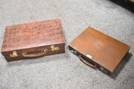 Two vintage leather briefcases with metal hard wear, (2), condition is consistent with age and use.