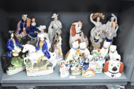 A large quantity of 19th century Staffordshire pottery, to include large flat-backs of English