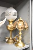 A large Victorian brass and glass converted oil lamp with a frosted and etched glass orb-formed