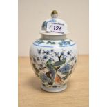 A late 20th-century Chinese porcelain ginger jar, featuring a gilt finial, lidded rim, and decorated
