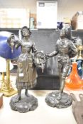 A pair of French bronzed spelter statues, featuring a female titled Marchande de Volailles (