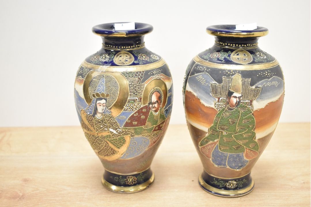 A pair of 20th-century Japanese Satsuma ware vases, featuring foliate and floral decoration with - Image 1 of 3