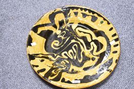 A large 20th century studio pottery slipware ceramic serving platter having yellow and brown