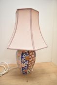 A 20th-century Japanese Fukagawa Arita Imari ware-style lamp base with a pale pink fabric shade,