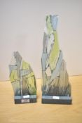 Two slate based art/studio glass ornaments, of irregular 'rocky' outline with applied texture and