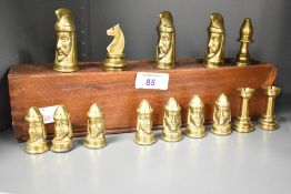 A selection of 20th-century Tigani Gothic-style brass chess pieces, with wooden storage box, (14).