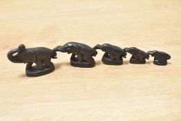 Set of five 20th-century iron tribal art graduated elephant-shaped weights, in which the trunk of