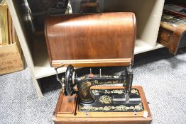 A vintage Singer sewing machine, serial number R1557225 complete with lockable case.