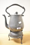 A large Victorian pewter alloy spirit kettle and stand, featuring an ornately formed handle with