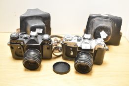 Two Zenit E cameras, one silver and black, the other black, both with Helios 58mm f2 44-2 lenses,