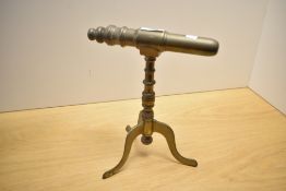 A 19th-century brass goffering iron on a tripod base, traditionally used to create ruffs, ribbons,