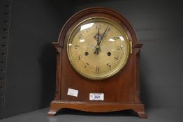 A 20th-century 'Turkish'-style arched mahogany mantel clock, converted to quartz of Arabic numerals,