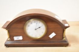 A 19th-century French arched mahogany mantel clock,having an 8-day French movement and Arabic