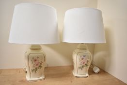 Two 20th-century ceramic table lamps, having delicate pink floral decoration with gilded detailing