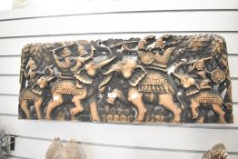 A large 20th-century hand-carved wooden wall panel, presumed to be from Southeast Asia, depicting