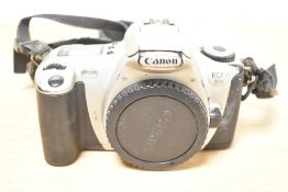 Three Canon SLR cameras, a Canon EOS 300D digital camera, a Canon EOS 300 35mm film camera, and a