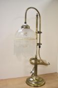 A 20th-century Art Deco style gilt metal gooseneck bridge arm lamp with a frosted glass fringed
