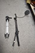 Two photography tripods, one with a microphone pop filter.