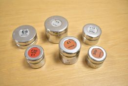 A quantity of 20th-century chrome-plated metal money checker weights, historically used by banks and