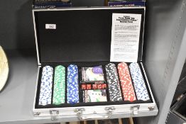 A modern Cardinal 300-piece poker chip set in an aluminium carrying case, accompanied by original
