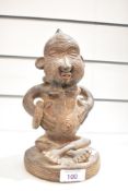 A small 20th-century African Tribal Art carved stoneware seated statue, presumed to be a fertility