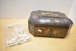 A 19th-century Chinese black and gilded lacquer sewing box, of octagonal form with a rolled top