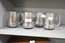 A set of five 20th-century studio art glass tankard-style mugs, pontil mark to base, (5),
