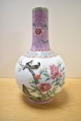 A large Chinese porcelain famille rose bottle base, having a globular body issuing a spreading