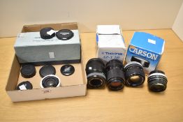 A collection a lenses. A Canon 100mm f2.8, a Carl Zeiss Jena 135mm f3.5, a Hanimex 28mm f2.8,