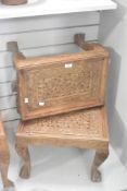 Two small 20th-century Indian hand-carved wooden tables, featuring intricate open fret work of